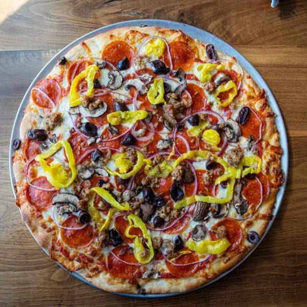 A Humble Tomato pizza with pepperoni, sausage, mushrooms, olives, red onion, and banana peppers.